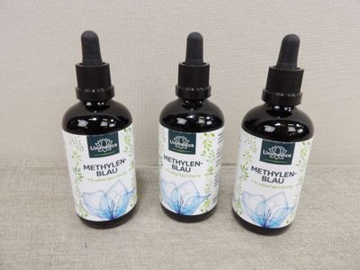 three bottles of metylen blend sitting on top of a table