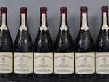 six bottles of wine are lined up in a row on a table