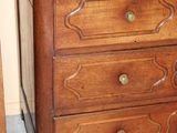 a wooden dresser with a mirror on top of it