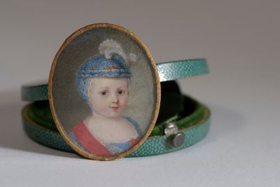 a picture of a miniature portrait of a young girl in a blue hat