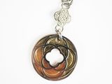a close up of a necklace with a flower on it
