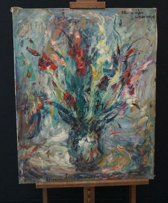 a painting of flowers in a vase on an easel