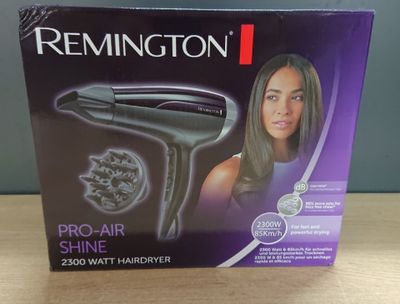 packaging of a hair dryer sitting on top of a wooden table