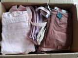 a box full of clothes that is sitting on the floor