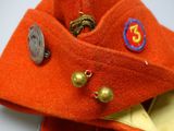 a close up of a red hat with buttons on it