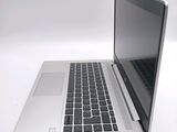 a silver laptop with a black keyboard on a white surface