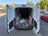 a white van with its doors open in a parking lot