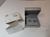 a box that has two rings in it on a table