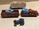 three toy tractors and a train car on a table