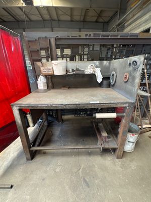 a workbench in the middle of a room with a red door