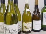 several bottles of wine are lined up on a table