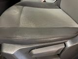 a close up of a seat in a car with a remote control