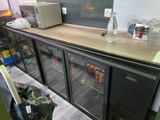 a counter with a bunch of bottles of water on top of it