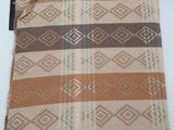 a brown and tan bag with fringes on it sitting on a table