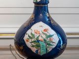 a blue vase sitting on top of a wooden table