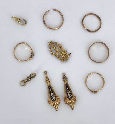 an image of a collection of gold rings and rings on a white surface