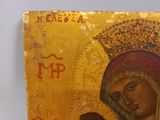 an old icon of the virgin and child is displayed on a table