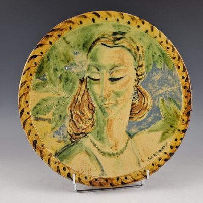 a plate with a painting of a woman on it
