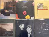 a lot of different album covers on a table