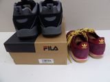 two pairs of shoes sitting on a box on a table