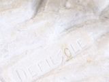 a banana that is sitting on top of a marble statue