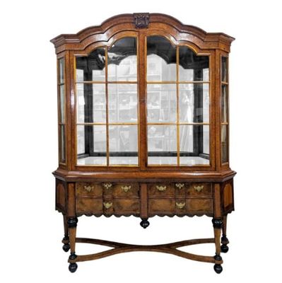 an old wooden china cabinet with glass doors and drawers