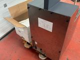 an open box sitting on top of a cart in front of a garage door