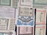 several different types of old and new currency are displayed on a table