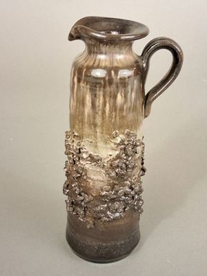 a vase that is sitting on a table with a white background