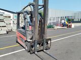 a forklift that is sitting in the middle of a parking lot