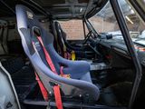 two seats in the back of a truck with a red seat belt