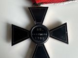 an image of a medal with a cross on it on a table