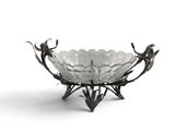 an image of a glass bowl with flowers and leaves on it
