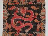 an oriental rug with a red dragon on a black background