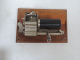 a small metal device that is on a wooden board