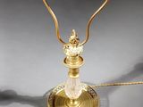 an antique brass table lamp with a glass shade and a metal base