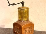 a small wooden grinder sitting on a counter