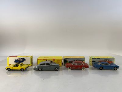 four toy cars are lined up in a row on a white surface