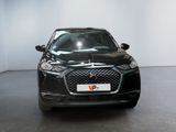 the front view of a black car in a white room
