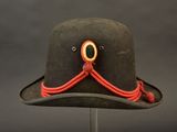 a black hat with a red string around the brim of it