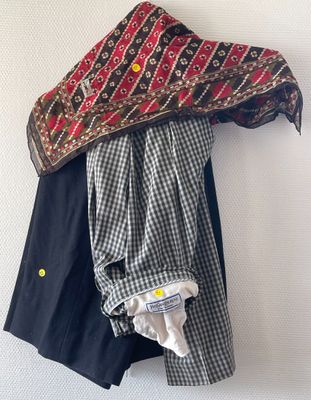 a black and white checkered shirt hanging on a wall