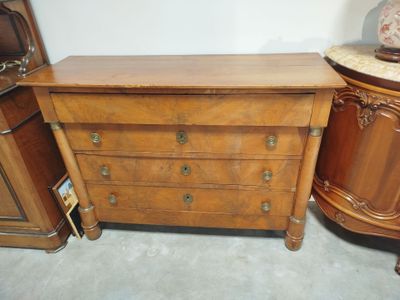 a dresser with a mirror on top of it and a lamp on top of it
