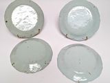 four pieces of glass sitting on top of each other on a white surface
