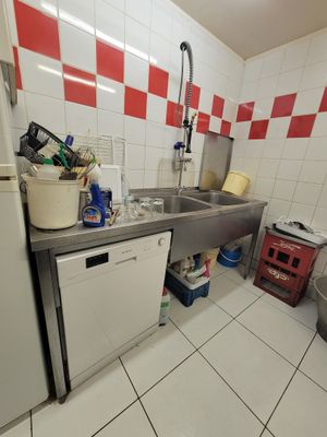a kitchen with a sink, dishwasher, and refrigerator in it