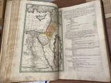 an open book with a map on it sitting on a table