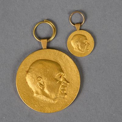 un gros plan d'une médaille d'or sur laquelle figure un visage