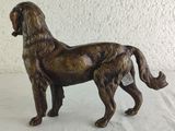 a statue of a dog that is standing on a table