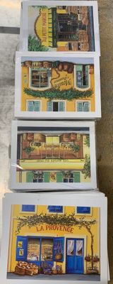 four boxes of miniature buildings sitting on the floor