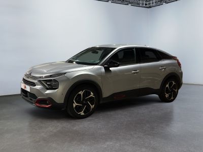 a silver suv parked in a large room with a white wall