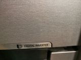 a digital inverter on the side of a stainless steel refrigerator